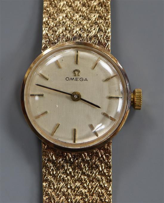 An Omega 9ct gold ladys' wristwatch on textured bracelet, with box and papers